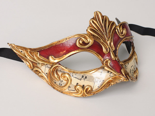 Masquerade mask in red and gold , Venetian mask in red and gold .